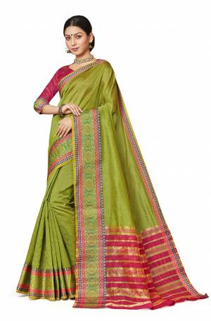 Celebrate This Festive Season With Beauty And Comfort Wearing This Designer Silk Based Saree In Parrot Green Color Paired With Contrasting Rani Pink Colored Blouse. This Saree And Blouse are Fabricated On Art Silk Beautified With Weaved Border. 