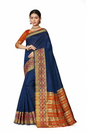 Celebrate This Festive Season With Beauty And Comfort Wearing This Designer Silk Based Saree In Navy Blue Color Paired With Contrasting Orange Colored Blouse. This Saree And Blouse are Fabricated On Art Silk Beautified With Weaved Border. 