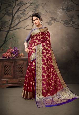 Here Is A Royal Looking Heavy Weaved Designer Saree In Maroon Color Paired With Contrasting Purple Colored Blouse. This Saree And Blouse Are Fabricated On Banarasi Art Silk Beautified With Weave All Over.