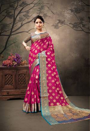Shine Bright Wearing This Designer Silk Based Saree In Dark Pink Color Paired With Contrasting Blue Colored Blouse. This Saree And Blouse Are Fabricated on Banarasi Art Silk Beautified With Weave. Buy This Saree Now.