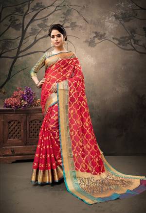 Get Ready For The Upcoming Festive And Wedding Season With This Designer Silk Based Saree In Red Color Paired With Contrasting Teal Blue Colored Blouse. It IS Beautified With Heavy Weave Which Will Earn You Lots Of Compliments From Onlookers. 