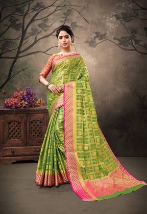 Look Pretty And Earn Lots Of Compliments In This Silk Based Saree In Green Color Paired With Contrasting Dark Pink Colored Blouse. Its Attractive Weave And Pretty Color Pallete Will Earn You Lots Of Compliments From Onlookers. 