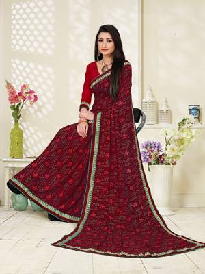 Rich And Elegant Looking Printed Saree Is Here In Maroon Color Paired With Red Colored Blouse. This Saree And Blouse Fabricated on Georgette Beautified With Prints, Its Fabric Ensures Superb Comfort all Day Long. 