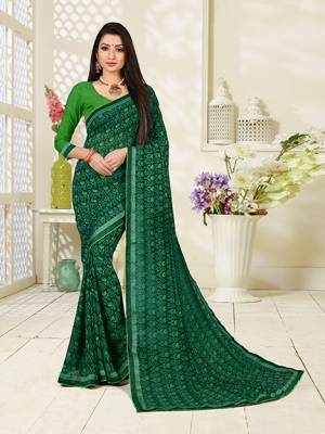 For Your Casuals Or Semi-Casuals, Grab This Lovely Saree In Green Color Paired With Green Colored Blouse. This Georgette Based Saree Is Beautified With Small Butti Prints All Over.