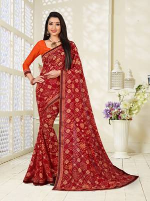 Add This Pretty Saree To Your Wardrobe For Casual Wear In Red Color Paired With Contrasting Orange Colored Blouse. This Saree And Blouse Are Fabricated On Georgette Beautified With All Over Butti Print. It Is Light In Weight And Easy To Carry All Day Long. 