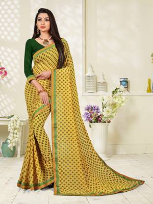 For Your Casuals Or Semi-Casuals, Grab This Lovely Saree In Yellow Color Paired With Green Colored Blouse. This Georgette Based Saree Is Beautified With Small Butti Prints All Over.