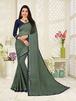 Add This Pretty Saree To Your Wardrobe For Casual Wear In Grey Color Paired With Contrasting Navy Blue Colored Blouse. This Saree And Blouse Are Fabricated On Georgette Beautified With All Over Butti Print. It Is Light In Weight And Easy To Carry All Day Long. 
