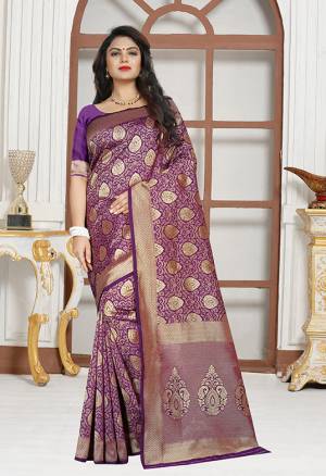 Here Is A Very Pretty Designer Saree In Purple Color Paired With Purple Colored Blouse. This Saree And Blouse are Silk Based Beautified With Paisly Weave All Over It. Buy This Saree Now.