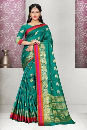 Grab This Pretty Saree In Teal Green Color Paired With Teal Green Colored Blouse. This Saree And Blouse are Fabricated On Cotton Silk Beautified With Folk Design Weave. Buy This Saree Now.