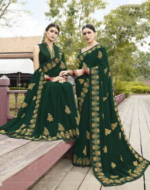 Celebrate This Festive Season With Beauty And Comfort Wearing This Designer Saree In Dark Green Color paired With Dark Green Colored Blouse. This Saree Is Fabricated On Georgette Paired With Art Silk Fabricated Blouse. Its Traditional Color And Embroidery Will earn You Lots Of Compliments From onlookers.