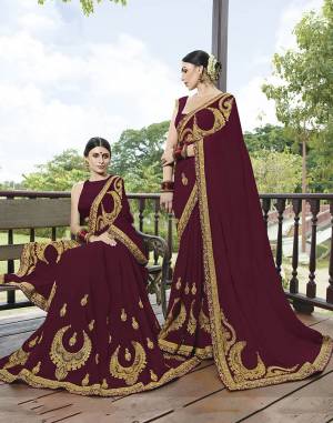 For A Royal And Elegant Look, Grab This Designer Saree In Rich Maroon Color Paired With Maroon Colored Blouse. This Saree Is Georgette Based Paired With Art Silk Fabricated Blouse. It Is Beautified With Bold And Attractive Embroidered Motifs. 