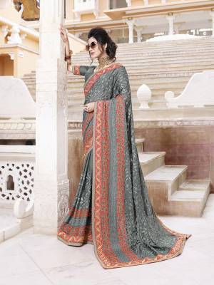 Flaunt Your Rich And Elegant Taste Wearing This Heavy Designer Saree With Tone To Tone Emnbroidery In Grey Color Paired With Grey Colored Blouse. This Pretty Saree Is Chiffon Based Paired With Art Silk Fabricated Blouse. 