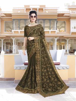 Enhance Your Personality Wearing This Heavy Designer Saree In New Dark Olive Green Color Paired With Dark Olive Green Colored Blouse. This Saree Is Fabricated On Chiffon Paired With Art Silk Fabricated Blouse. It Has Attractive Cut Work Lace Border With Tone To Tone Embroidery All Over It.