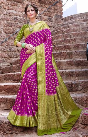 Grab This Beautiful And Attractive Looking Designer Silk Based Saree In Magenta Pink Color Paired With Contrasting Green Colored Blouse. This Saree And Blouse Are Fabricated On Nylon Art Silk Beautified With Weave And Stone Work. 