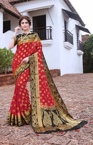 Here Is An Attractive Designer Silk Based Saree In Red Color Paired With Black Colored Blouse. This Saree And Blouse Are Fabricated On Nylon Art Silk Beautified With Weave And Stone Work. This Pretty Saree Is Suitable For Festive Wear Or Any Social Gatherings. 