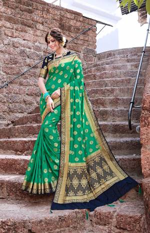 Add This Very Pretty Designer Silk Based Saree To Your Wardrobe For The Upcoming Festive Season With This Saree In Sea Green Color Paired With Contrasting Navy Blue Colored Blouse. This Saree And Blouse Are Fabricated On Nylon Art Silk Which Gives A Rich Look To Your Personality. 