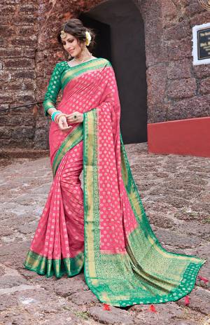 Grab This Beautiful And Attractive Looking Designer Silk Based Saree In Pink Color Paired With Contrasting Green Colored Blouse. This Saree And Blouse Are Fabricated On Nylon Art Silk Beautified With Weave And Stone Work. 