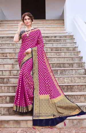 Here Is An Attractive Designer Silk Based Saree In Magenta Pink Color Paired With Black Colored Blouse. This Saree And Blouse Are Fabricated On Nylon Art Silk Beautified With Weave And Stone Work. This Pretty Saree Is Suitable For Festive Wear Or Any Social Gatherings. 