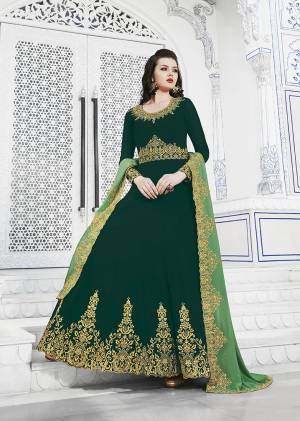 Celebrate This Festive Season Wearing This Designer Floor Length Suit In Dark Green Color Paired With Light Green Colored Dupatta. Its Top Is Fabricated On Georgette Beautified With Embroidery Over Yoke And Panel Paired With Santoon Bottom And Georgette Fabricated Cut Work Embroidered Dupatta. 