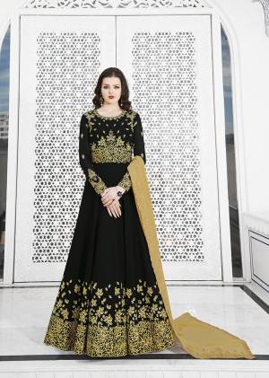 For A Bold and Beautiful Look, Grab This Designer Floor Length Suit In Black Color Paired With Black Colored Bottom And Beige Colored Dupatta. Its Top IS Georgette Based Beautified With Heavy Embroidery Over Yoke And Panel Paired With Santoon Bottom And Georgette Fabricated Cut Work Dupatta. 