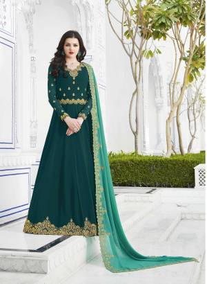 New And Unique Shade Is Here To Add Into Your Wardrobe With This Designer Floor Length Suit In Teal Blue Color Paired With Contrasting Turquoise Blue Colored Dupatta. This Pretty Suit Is Georgette Based Beautified With Heavy Jari Embroidery And Stone Work. Buy This Now.