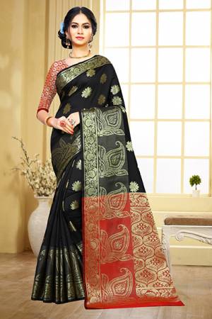 Grab This Beautiful Designer Silk Based Saree In Black Color Paired With Contrasting Red Colored Blouse. This Saree And Blouse Are Fabricated On Art Silk Beeautified With Weave Motifs All Over The Saree. This Saree Is Durable, Light Weight And Easy To Carry All Day Long. 