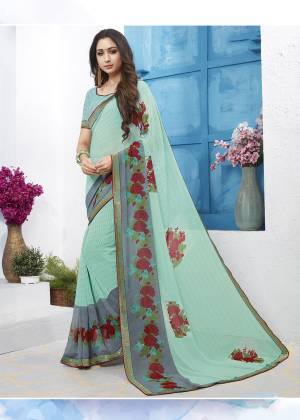 Look Pretty In This Lovely Printed Saree In Aqua Blue Color Paired With Aqua Blue Colored Blouse. This Pretty Saree And Blouse Are Georgette Based Beautified With Contrasting Floral Prints All Over It. 