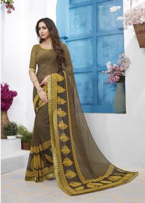 For Your Casuals Or Semi-Casuals, Grab This Pretty Saree In Brown Color Paired With Brown Colored Blouse. This Saree And Blouse Are Fabricated On Georgette Beautified With Prints All Over It.