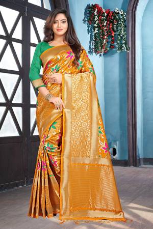 Here Is A Very Pretty Designer Silk Based Saree In Musturd Yellow Color Paired With Contrasting Green Colored Blouse. This Saree And Blouse Are Silk Based Beautified With Weave. It Is Light Weight And Durable, Easy To Carry Throughout The Gala. 