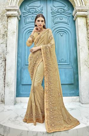 Simple And Elegant Looking Heavy Designer Saree Is Here In Beige Color Paired With Beige Colored Blouse. This Saree Is Fabricated On Satin Silk Paired With Art Silk Fabricated Blouse. It Is Beautified With Heavy Embroidery. Buy This Rich Saree Now.