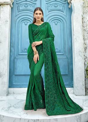 Celebrate This Festive Season With Beauty And Comfort Wearing This Designer Saree In Dark Green Color Paired With Dark Green Colored Blouse. This Saree Is Fabricated On Satin Silk Paired With Art Silk Fabricated Blouse. It Has Pretty Tone To Tone Resham Embroidery With Stone Work.