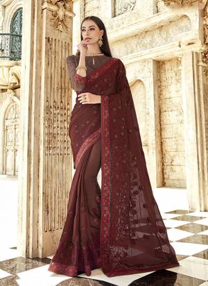 Here Is Beautiful Designer Saree In A Royal Look In Maroon Color. This Pretty Tone To Tone Embroidered Saree Is Georgette Based Paired With Art Silk Fabricated Blouse. It Is Light Weight And Easy To Carry Throughout The Gala. 