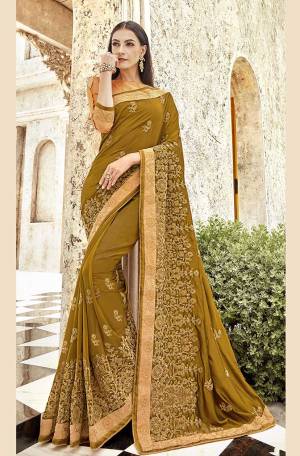 New And Unique Shade Is Here To Add Into Your Wardrobe With This Designer Saree In Pear Green Color Paired With Beige Colored Blouse. This Saree Is Fabricated On Satin Georgette Paired With Art Silk Fabricated Blouse. Its Fabric Is Soft Towards Skin And Ensures Superb Comfort. 