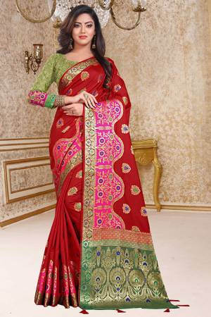 For A Proper Traditional Look, Grab This Designer Silk Based Saree In Red Color Paired With Contrasting Green Colored Blouse. This Saree And Blouse are Fabricated On Soft Silk Beautified With Weave. 