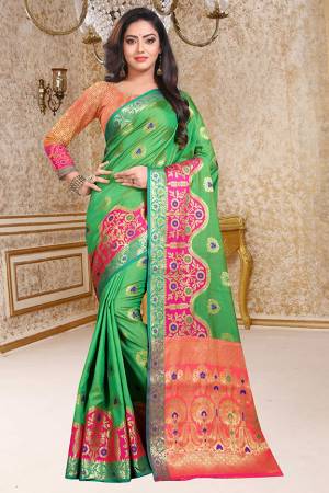 Celebrate This Festive Season With Beauty And Comfort In This Pretty Green Colored Saree Paired With Contrasting Dark Peach Colored Blouse. This Saree And Blouse Are Fabricated Soft Silk Beautified With Weave All Over. Buy This Saree Now. 