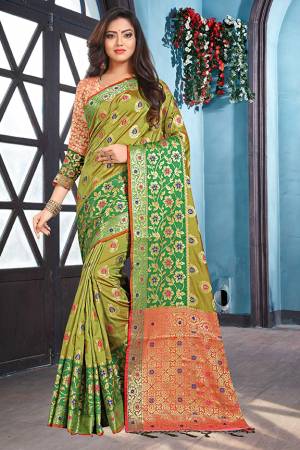 Celebrate This Festive Season With Beauty And Comfort In This Olive Green Colored Saree Paired With Contrasting Dark Peach Colored Blouse. This Saree And Blouse Are Fabricated Soft Silk Beautified With Weave All Over. Buy This Saree Now. 