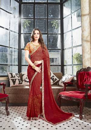 For A Pretty Royal Look, Grab This Saree In Maroon Color Paired With Contrasting Orange Colored Blouse. This Saree Is Fabricated On Georgette Paired With Art Silk Fabricated Blouse. This Saree and Blouse Are Beautified With Floral Prints All Over. 