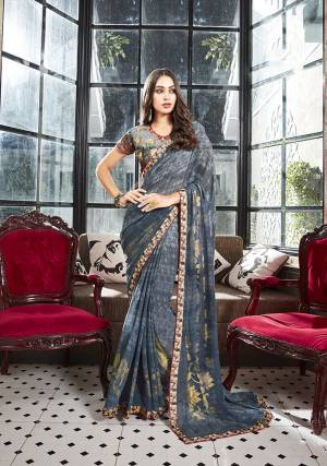 Enhance Your Personality Wearing This Lovely Floral Printed Saree In Dark Grey Color Paired With Dark Grey Colored Blouse. This Saree Is Georgette Based Paired With Art Silk Fabricated Blouse. It Is Beautified With Foil And Floral Prints. 