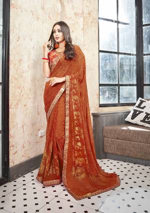 For A Pretty Royal Look, Grab This Saree In Rust Orange Color Paired With Rust Orange Colored Blouse. This Saree Is Fabricated On Georgette Paired With Art Silk Fabricated Blouse. This Saree and Blouse Are Beautified With Floral Prints All Over. 