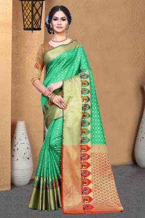 Rich And Elegant Looking Silk Based Designer Saree Is Here In Green Color Paired With Contrasting Orange Colored Blouse. This Saree And Blouse Are Fabricated On Patola Art Silk Beautified With Weave All Over. 