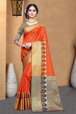Rich And Elegant Looking Silk Based Designer Saree Is Here In Orange Color Paired With Contrasting Navy Blue Colored Blouse. This Saree And Blouse Are Fabricated On Patola Art Silk Beautified With Weave All Over. 