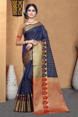 Celebrate This Festive Season With Beauty And Comfort Wearing This Designer Silk Based Saree In Navy Blue Color Paired With Contrasting Red Colored Blouse. This Saree And Blouse Are Fabricated On Patola Art Silk Beautified With Weave. 