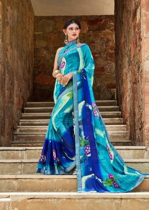 Simple Saree IS Here For Your Casual Or Semi-Casual Wear In Shades Of Blue. This Saree And Blouse Are Fabricated On Weightless Georgette Beautified With Prints And Lace Border. Buy This Saree Now.
