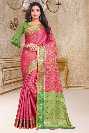 Enhance Your Personality In This Very Beautiful Heavy Weaved Silk Based Saree In Pink Color Paired With Contrasting Green Colored Blouse. This Saree And Blouse Are Fabricated On Patola Art Silk Beautified With Heavy Intricate Weave All Over. Buy This Saree Now.