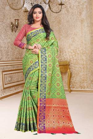 Enhance Your Personality In This Very Beautiful Heavy Weaved Silk Based Saree In Green Color Paired With Contrasting Pink Colored Blouse. This Saree And Blouse Are Fabricated On Patola Art Silk Beautified With Heavy Intricate Weave All Over. Buy This Saree Now.