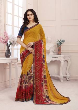 Grab This Pretty Printed Saree To Your Wardrobe For Semi-Casual Wear In Yellow And Red Color Paired With Contrasting Navy Blue Colored Blouse. This Saree Is Fabricated On Georgette Paired With Art Silk Fabricated Blouse. Buy Now.