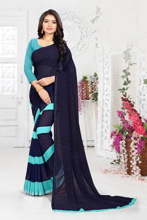 Enhance Your Personality In This Minimal Printed Saree In Navy Blue Color Paired With Aqua Blue Colored Blouse. This Saree And Blouse are Georgette Based Which Is Light Weight And Ensures Superb Comfort all Day Long. 