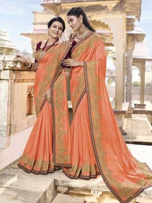 Get Ready For The Upcoming Festive And Wedding Season With This Heavy Designer Saree In Orange Color Paired With Contrasting Brown Colored Blouse. This Saree Is Fabricated On Soft Silk Paired With Art Silk Fabricated Blouse. It Is Beautified With Attractive Embroidery Over Border And Blouse. 