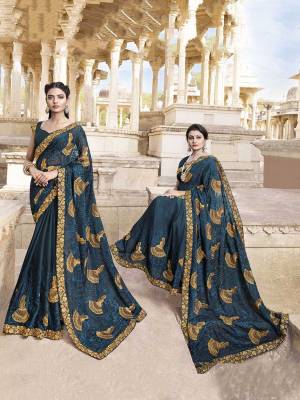 Catch All The Limelight At The Next Wedding You Attend Wearing This Vvery Beautiful And Heavy Designer Saree In Prussian Blue Color. This Saree Is Fabricated On Satin Silk Paired With Art Silk Fabricated Blouse. 