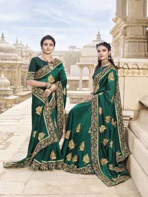 Add This Beautiful Heavy Designer Saree To Your Wardrobe In Dark Green Color Paired With Dark Green Colored Blouse. This Saree Is Fabricated On Satin Silk Paired With Art Silk Fabricated Blouse. Its Rich Fabric And Embroiodery Will Give You A Look Like Never Before. 